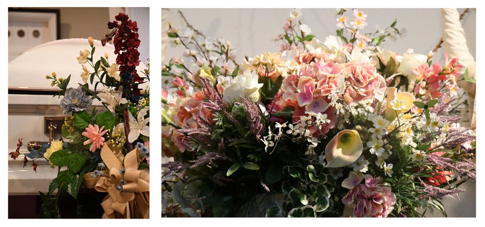 Flower arrangements beside a casket